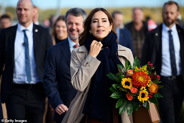 Mary braved cool temperatures, donning a trench coat and an oversized navy scarf