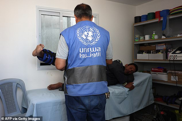 A UNRWA physiotherapist helps a Palestinian man at the Japanese Health Center in Khan Yunis, Gaza
