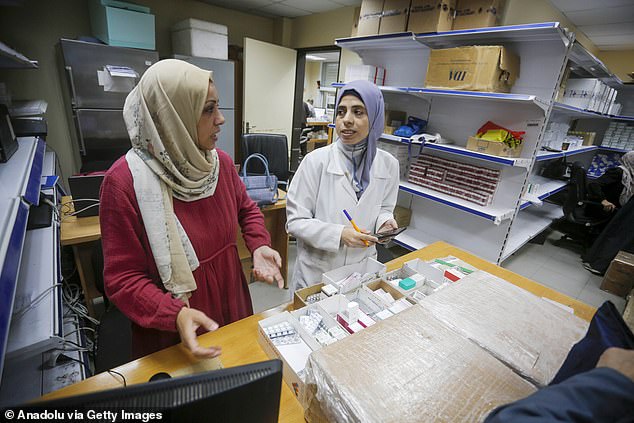 Two clinicians dispensing medication at the UNRWA centre. Labour and Tory stalwarts questioned if ministers were using all options available to force Israel¿s hand