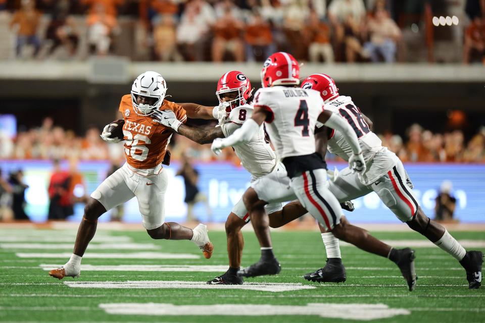 AUSTIN, TEXAS - OCTOBER 19: Quintrevion Wisner #26 of the Texas Longhorns runs the ball against Joenel Aguero #8 of the Georgia Bulldogs during the fourth quarter at Darrell K Royal-Texas Memorial Stadium on October 19, 2024 in Austin, Texas. (Photo by Alex Slitz/Getty Images)
