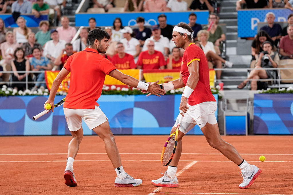 Rafael Nadal of Spain (R) and Carlos Alcaraz of Spain (L) after winning a point during the Tennis Men's Double Quarterfinal on day five of the Olym...