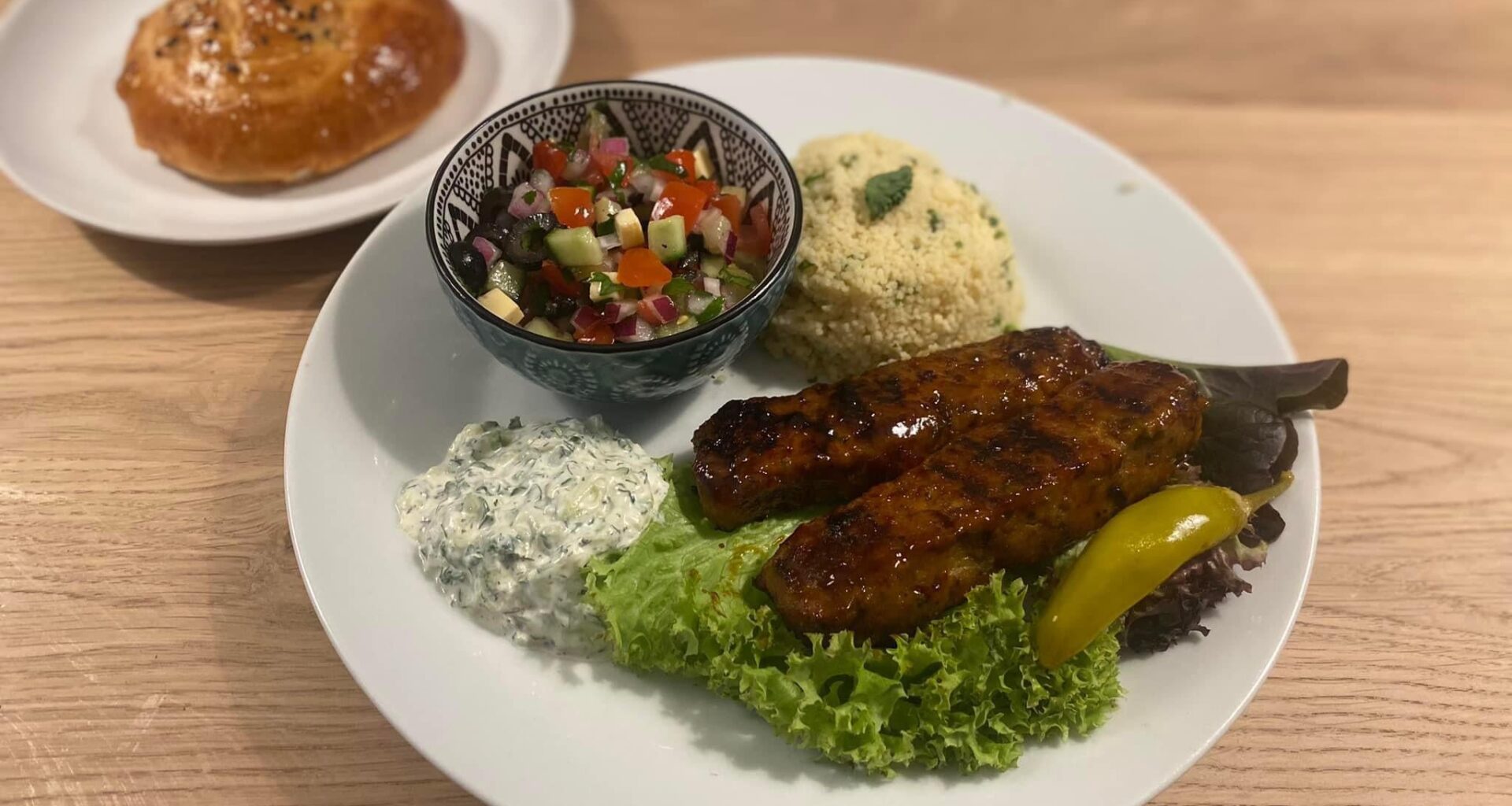 Turkish Adana kebab with coban salatasi, couscous and homemade Turkish mini bread