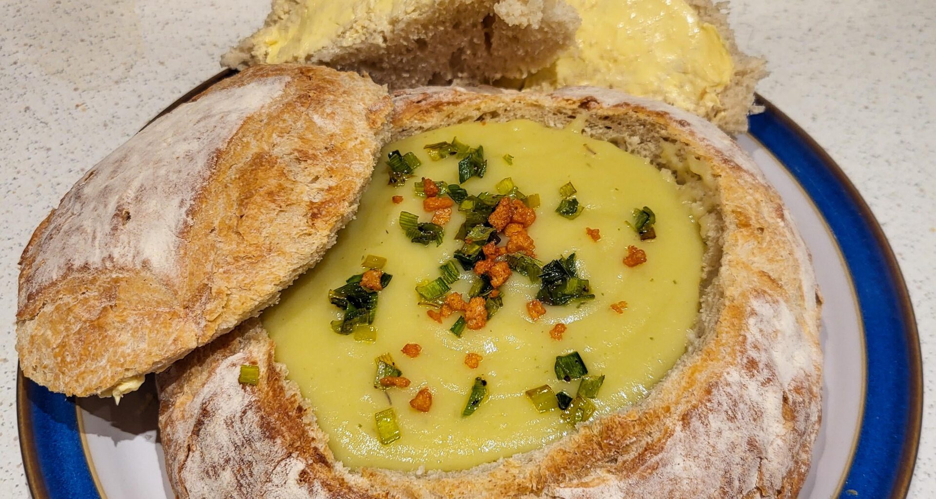 Homemade Leek & Potato Soup served in Stonebaked Boule with crispy fried Leek tops & Bacon bits
