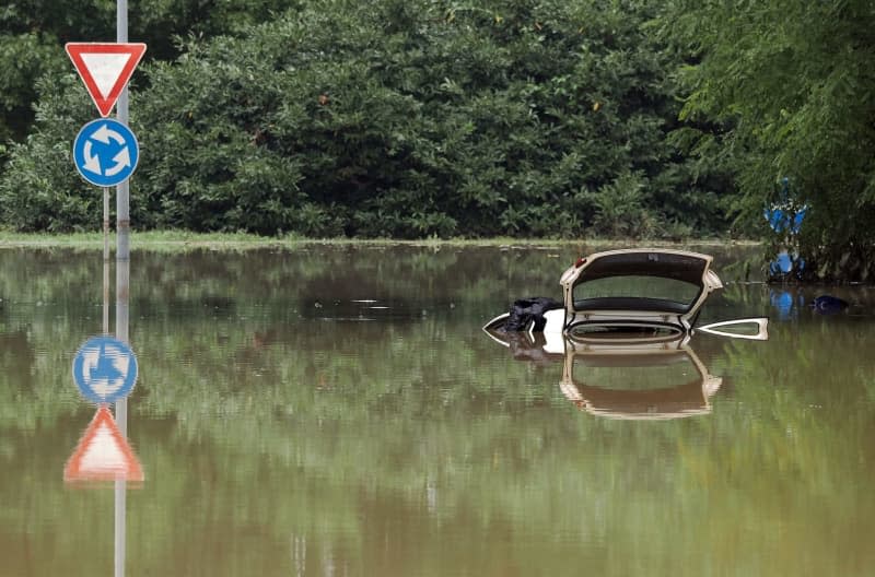 Water engulfs a car on a flooded street on the outskirts of the city. Michele Nucci/LaPresse via ZUMA Press/dpa