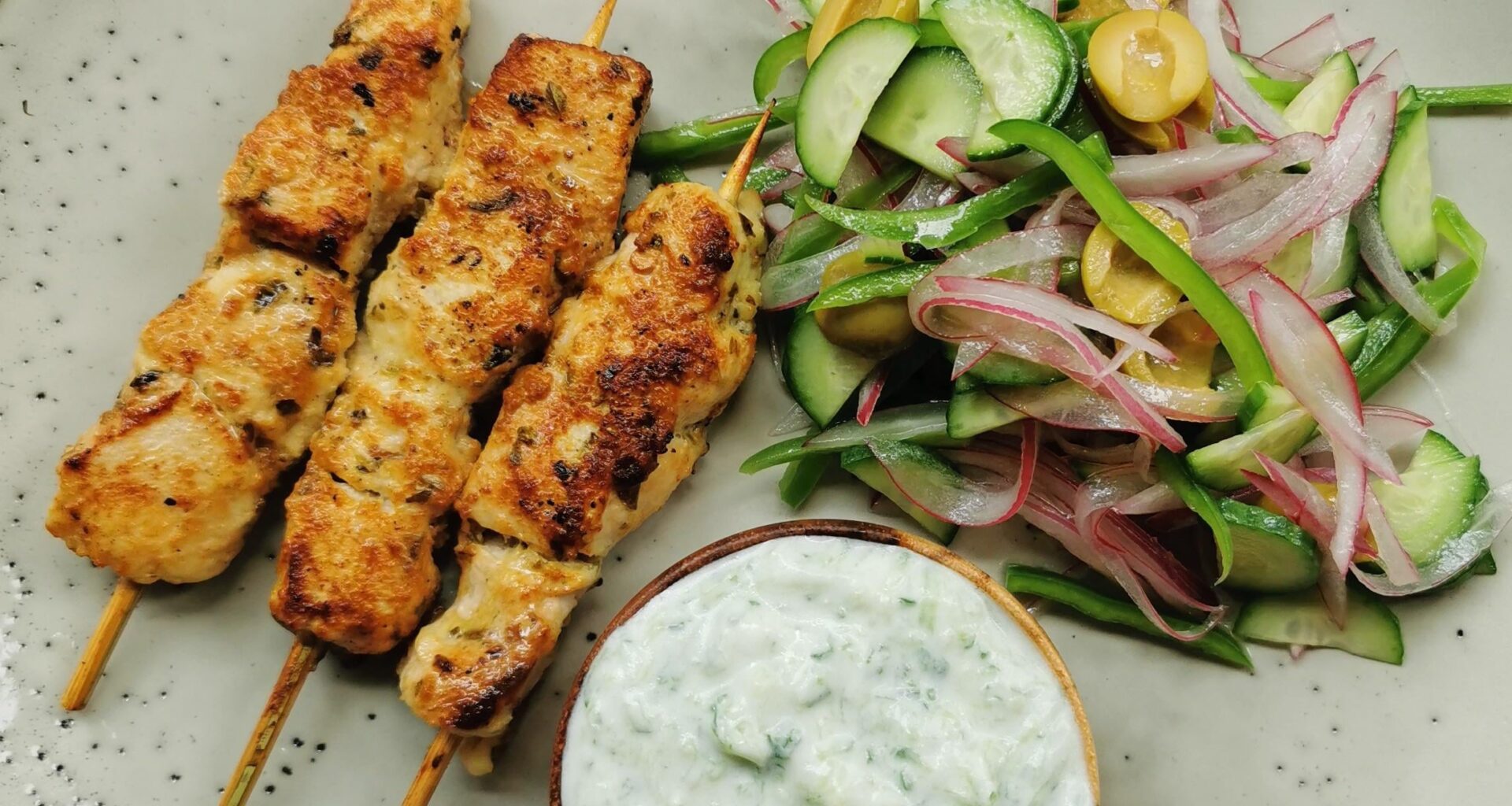 Greek style marinated chicken kabobs, salad and tzatziki lo