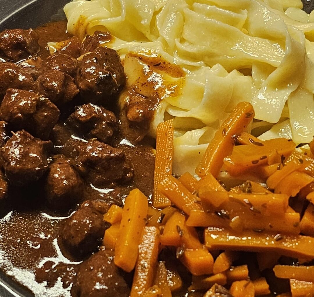 Meatballs made from Bratwurst meat and glazed caraway carrots from leftovers; served with Fettuccine