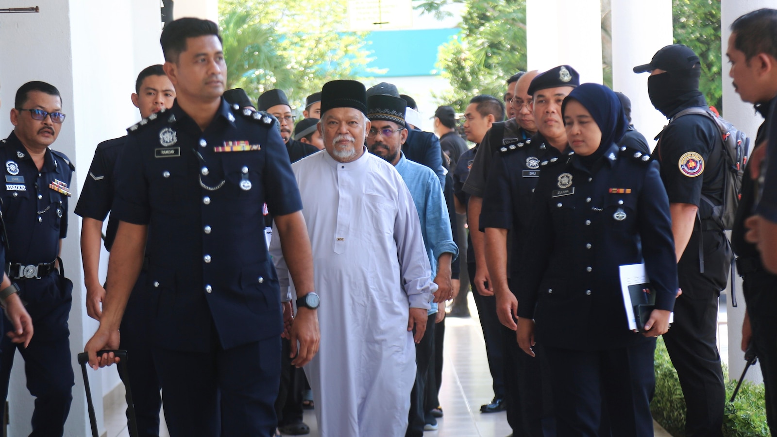 Malaysia charges 22 members of an Islamic business group, including its CEO, for organized crime