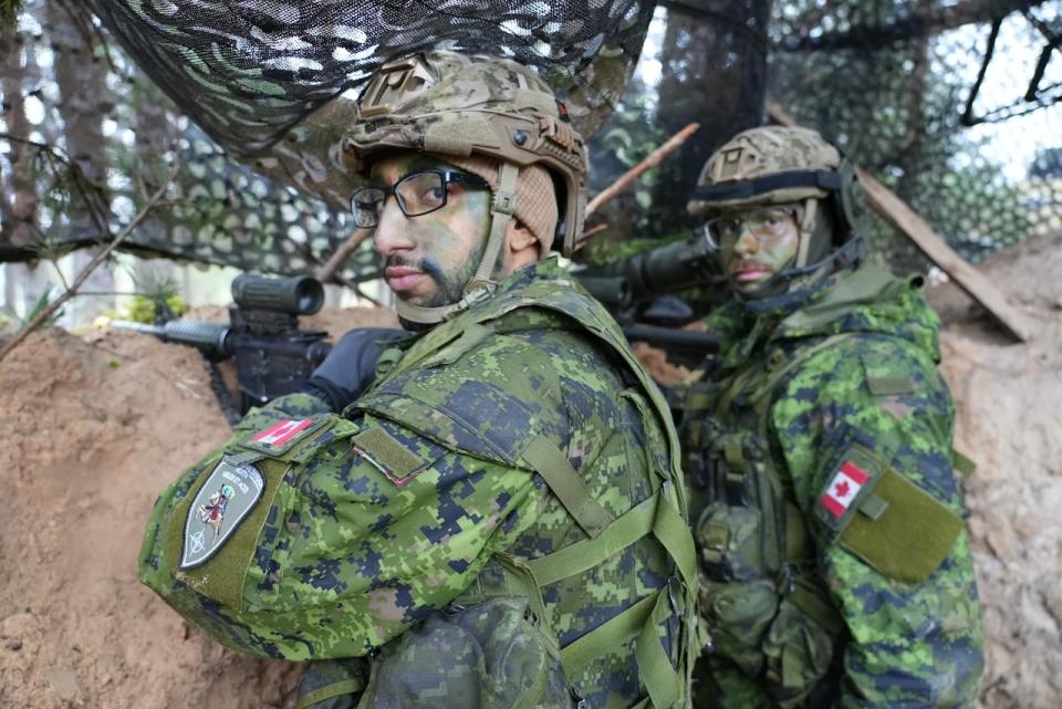 Corp Youssef Zitouni and Corp. Oliver Hutpays demonstrate how they would observe enemy movements from a trench during the exercises.