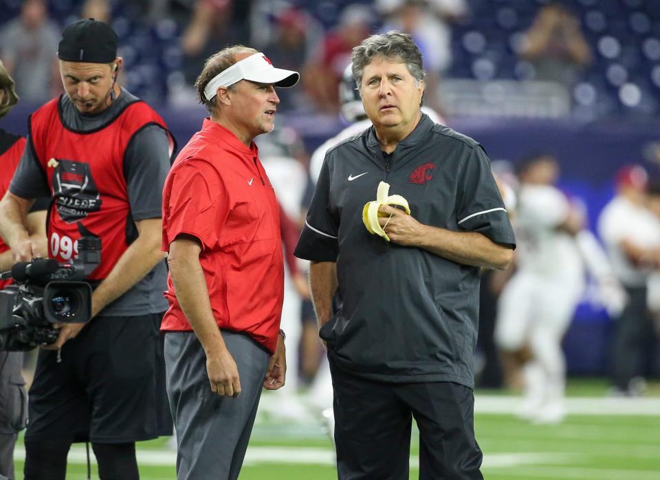 Sep 13, 2019; Houston, TX, USA; Houston Cougars head coach Dana Holgorsen and Washington State Cougars head coach Mike Leach talk on the field before a game at NRG Stadium. Mandatory Credit: Troy Taormina-USA TODAY Sports