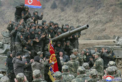 File photo: North Korean leader Kim Jong Un, center, meets soldiers who took part in a training in North Korea. Russia-Ukraine war: Why North Korean soldiers are ready to die for Putin