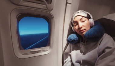 Woman sleeping on plane.