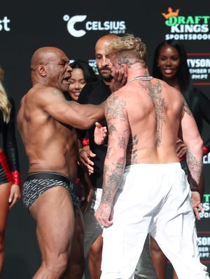 Mike Tyson slaps Jake Paul during Thursday's weigh-in.