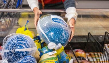 A shopper picks up a frozen turkey at a Walmart.