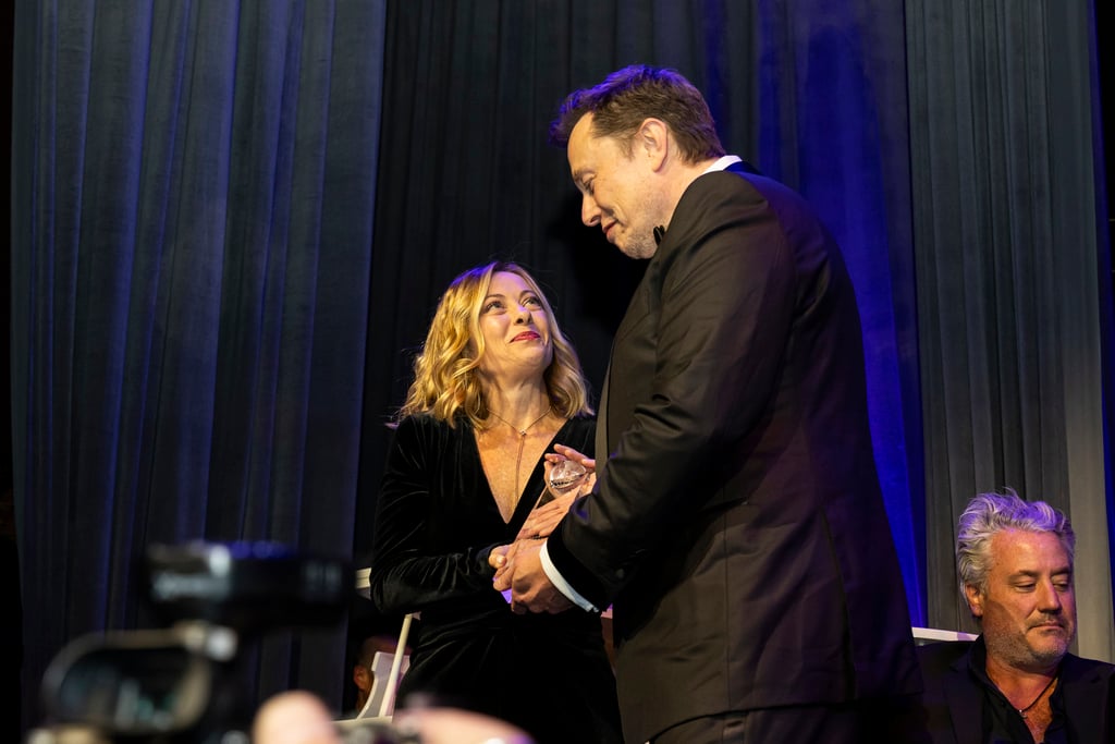 Elon Musk presents Italy’s President Giorgia Meloni with an award during the Global Citizen Awards. Photo: AP