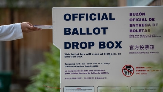 A voter submits their ballot at an official ballot drop box at a polling location for the 2024 Presidential election in Hercules, California, US, on Tuesday, Nov. 5, 2024. Photographer: David Paul Morris/Bloomberg(Bloomberg)