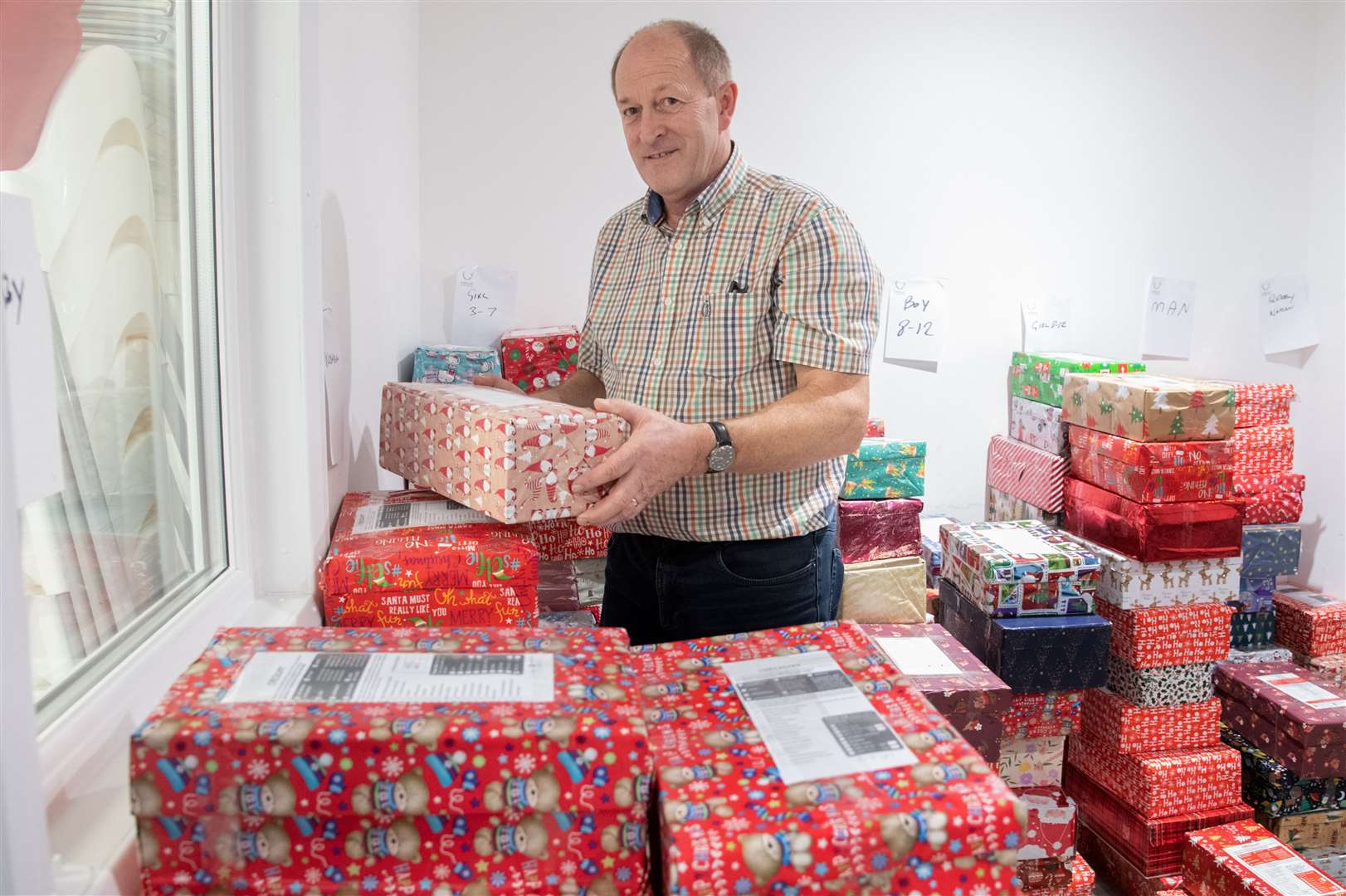 Co-organiser Kenneth McKilligan with some of the shoeboxes bound for Eastern Europe. Picture: Daniel Forsyth