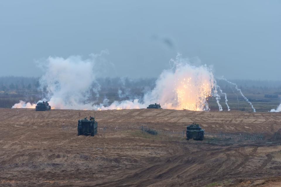 Smoke bombs go off during the military exercises. Canada expanded its deployment in Latvia in 2023, and is committed until at least 2026.