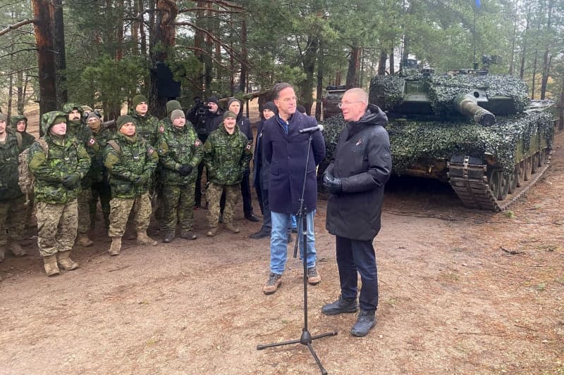 Latvian President Edgars Rinkevics (R) speaks to soldiers together with Nato Secretary General Mark Rutte. They visited a maneuver of the multinational NATO brigade stationed in Latvia, which is currently being formed and trained together at full strength for the first time. Alexander Welscher/dpa