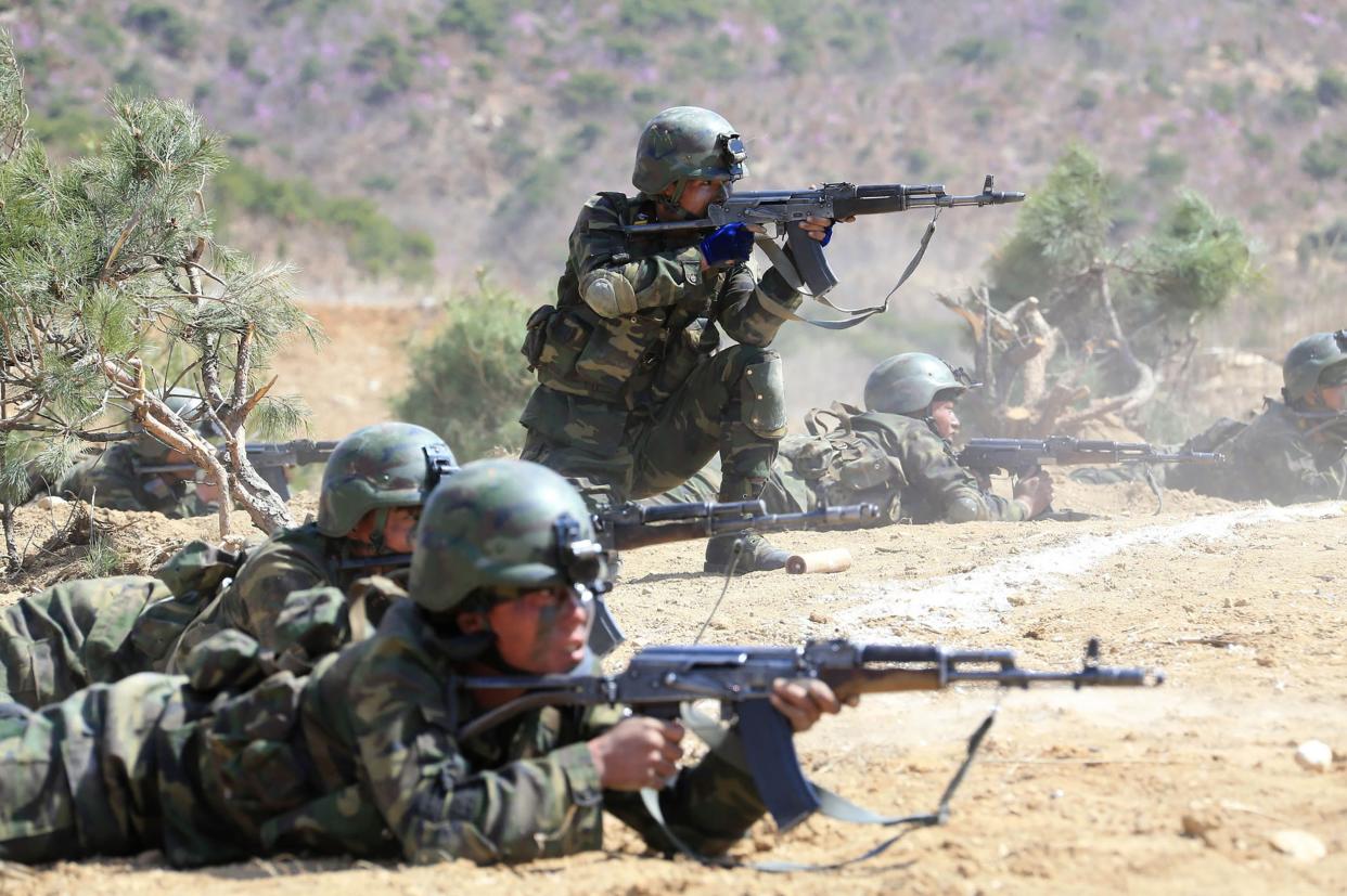 Soldiers identified by North Korean state media as elite commandos aim their AK combat rifles during an exercise.