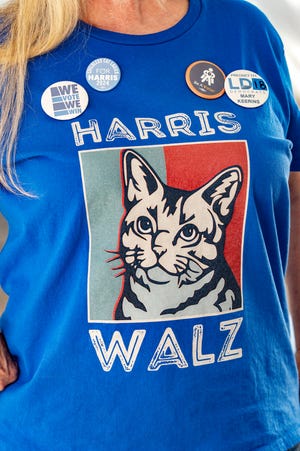 Mary Keerins, a democrat activist, wearing a cat T-shirt supporting Harriz Walz poses for a portrait, at the entrance to the Murphy-Wilmot Library in Tucson, Arizona, October 16, 2024. As their race for the US presidency comes down to the wire, each major candidate has leaned heavily on a favorite theme -- abortion rights for Democrat Kamala Harris and border security for Republican Donald Trump.
In Arizona, their ideological duel has reached a white-hot peak, with both topics the subject of fiercely debated ballot referendums. (Photo by Olivier Touron / AFP) (Photo by OLIVIER TOURON/AFP via Getty Images)