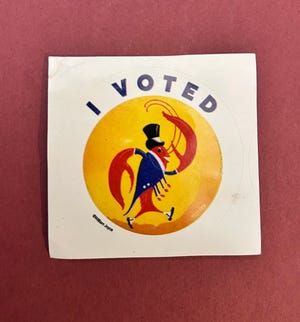 A crawfish in a top hat is on Lousianna's sticker. A Lousiana native, Robby Marshall, received his after he voted in Baton Rouge.