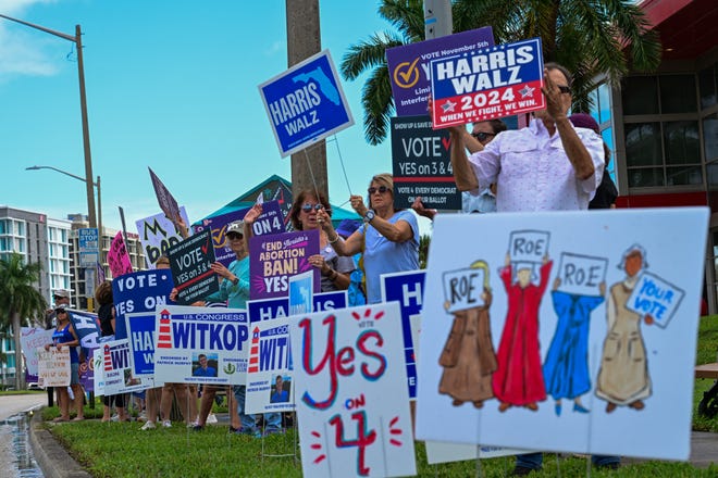 Demonstrators rally during the National Women's March in West Palm Beach, Fla., on Nov. 2, 2024.