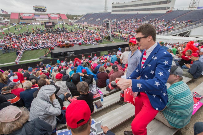 Trump supporter John Gallops, from Daphne, AL, joins others for a president-elect Donald Trump thank you rally at Ladd-Peebles Stadium on December 17, 2016 in Mobile, Alabama.