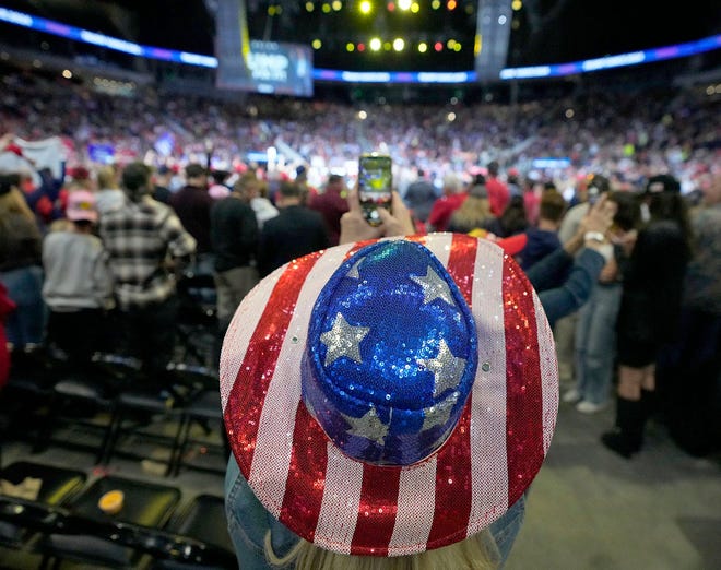 A Trump supporter takes video with her phone during Donald Trump's political rally at Fiserv Forum in Milwaukee on Friday.