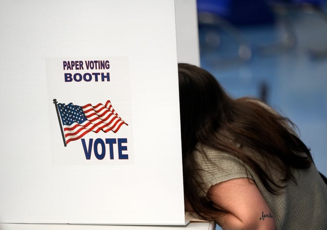 A voter uses the paper voting booth at Montrose Elementary School in Bexley on Tuesday.