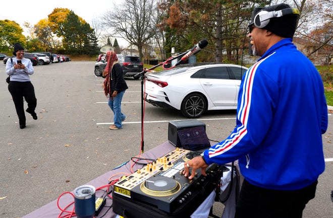 Voters dance as they head to their cars after voting as Carl Hollier, 50 of West Bloomfield, who goes by DJ Invisible, plays at the Bowens Senior Citizens Center in Pontiac where precincts four, five and six were located on Election Day, Tuesday, Nov. 5, 2024. Hollier is one of thousands of DJ’s around the country who are aiming to play at 8,5000 precincts as part of the “DJ’s at the Polls” organization.