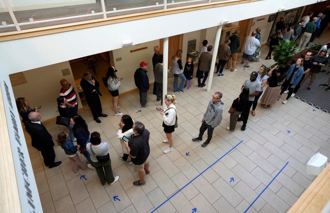 Arrows made with tape show voters where to stand at Congregation Agudas Achim in Bexley Tuesday morning. Voters said they waited about 45 minutes.