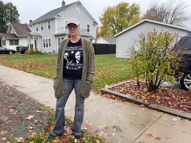 Jessica Robbins, of Appleton, discusses her shirt on the street outside her district’s polling place, Saint Matthew Lutheran Church in Appleton. She was asked to conceal her shirt, which reads “I like my presidents like I like my guns, 40 & 45” with images of the 40th U.S. president Ronald Reagan and the 45th U.S. president Donald Trump, in accordance with Wisconsin electioneering laws. She fastened the bottom button of her cardigan, but said that does not mean she agrees with the rule.