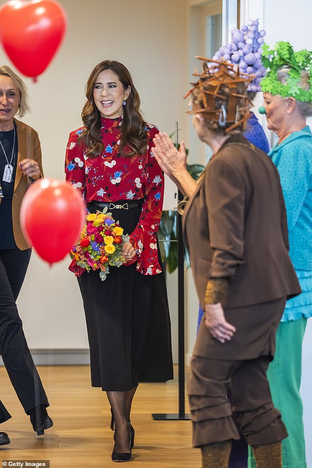 The following day, the royal couldn't hold back her laughter as she met with hospital clowns during a solo visit to the town of Middelfart
