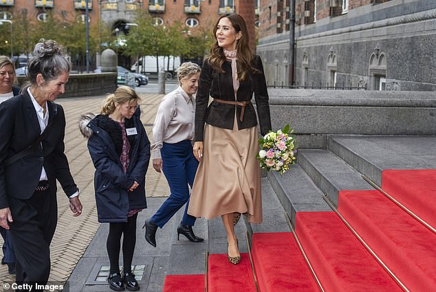 Mary smiled sweetly at onlookers as she climbed red carpeted steps outside Copenhagen City Hall