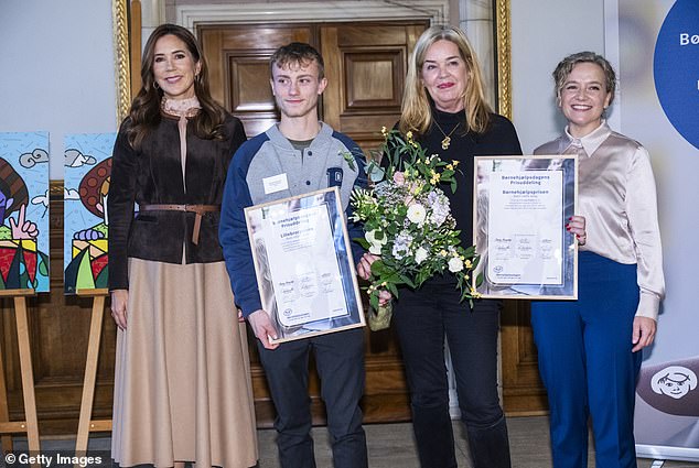 Attending the event without the company of her husband King Frederik, 56, Mary beamed from ear to ear as greeted officials in the Scandinavian capital