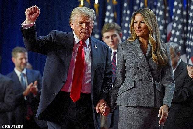 Republican presidential nominee and former U.S. President Donald Trump holds up a fist as he takes the stage with his wife Melania and son Barron, following early results from the 2024 U.S. presidential election in Palm Beach County Convention Center, in West Palm Beach, Florida, U.S., November 6, 2024