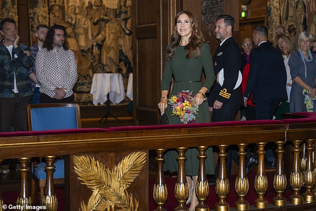 She accessorised with contrastingly bright orange drop earrings, a Dulong Fine Jewelry pearl bracelet and a pair of £650 snakeskin Gianvito Rossi pumps