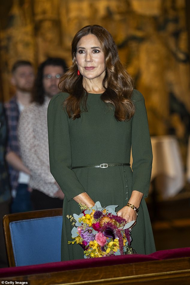 Mary looked ever-so-chic clutching a colourful bouquet of flowers in a deep green midi dress with three-quarter-length sleeves