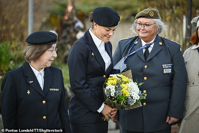 Victoria pictured with a bouquet. The SLK is an 'independent auxiliary defense organisation' which also works with other civil authorities