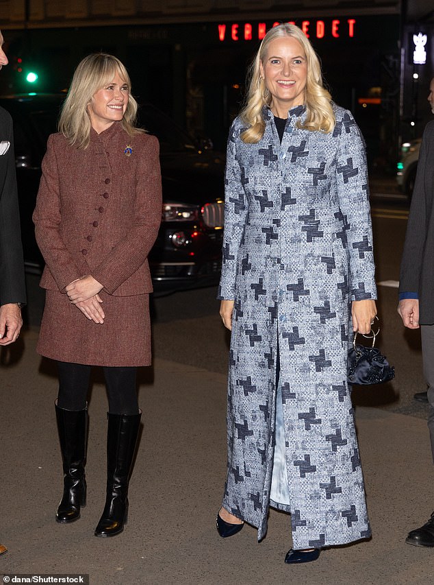 Mette-Marit opted for a full-length cross-patterned blue coat over a chic pair of navy trousers and simple heels