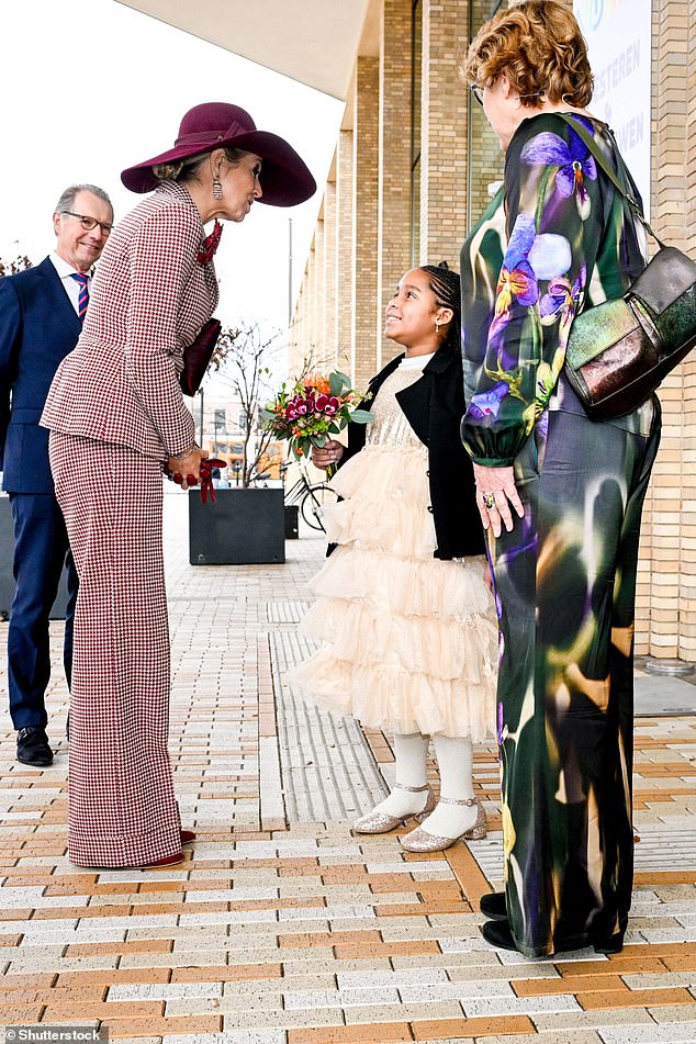 Arriving at the event on Wednesday, Maxima was spotted beaming as she bent down to shake hands with a young girl