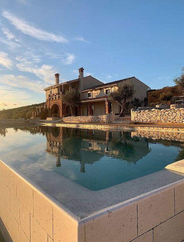 It boasts an outdoor kitchen and covered terrace with a fireplace, sundeck, playground, jacuzzi and gym