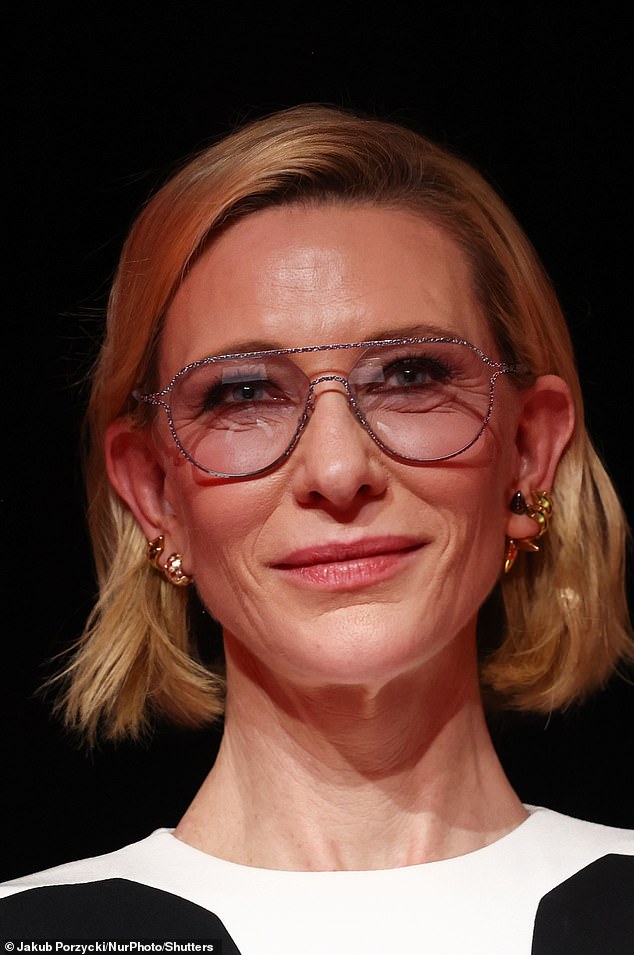 She wore a smokey eye and a lick of pink on her lips, before finishing off her look with silver framed glasses