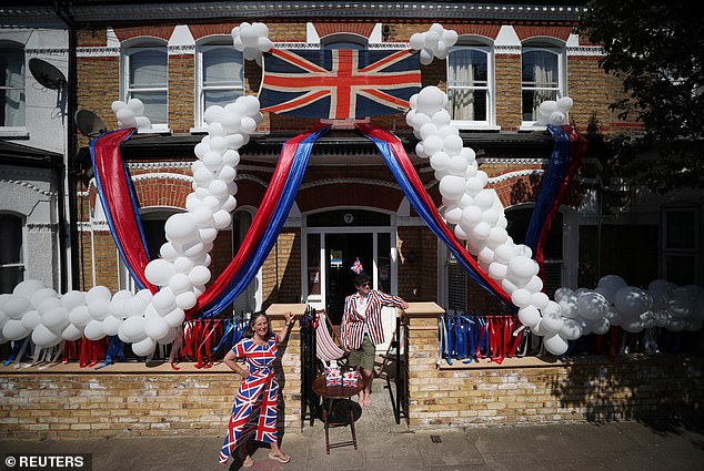Pictured are Jane and Toby Lyde outside their house in Tooting on the 75th Anniversary of VE Day, London in 2020