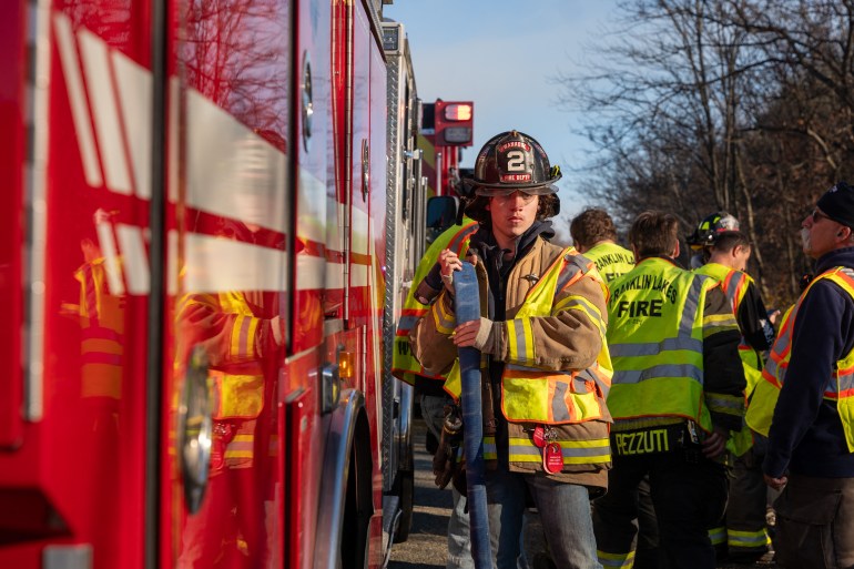 POMPTON LAKES, NEW JERSEY - NOVEMBER 09: Firefighters work on battling a series of brush fires on November 09, 2024 outside of Pompton Lakes, New Jersey. Much of the Northeast is experiencing drought conditions, leading to a series of brush fires in New York and New Jersey which have brought smokey haze to New York City and compromised the city's air quality. Brooklyn's Prospect Park saw over two acres burned last night in a brush fire as Mayor Eric Adams has announced a drought watch for the entire city. Spencer Platt/Getty Images/AFP (Photo by SPENCER PLATT / GETTY IMAGES NORTH AMERICA / Getty Images via AFP)