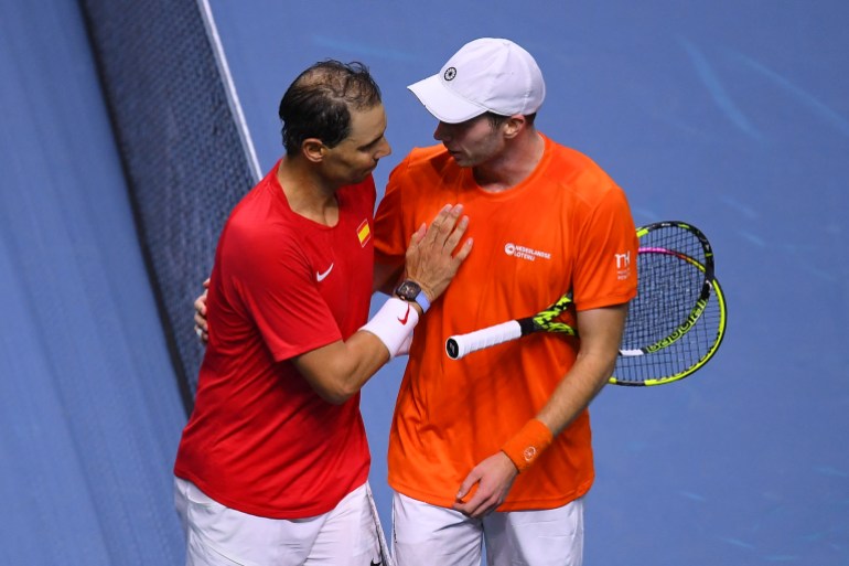 Tennis player shakes hands at end of match.