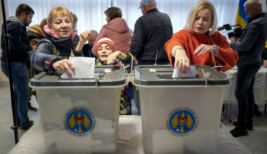 Women cast their vote in Chisinau, Moldova, Sunday, Oct. 20, 2024, during a presidential election and a referendum on whether to enshrine in the Constitution the country's path to European Union membership. (AP Photo/Vadim Ghirda)