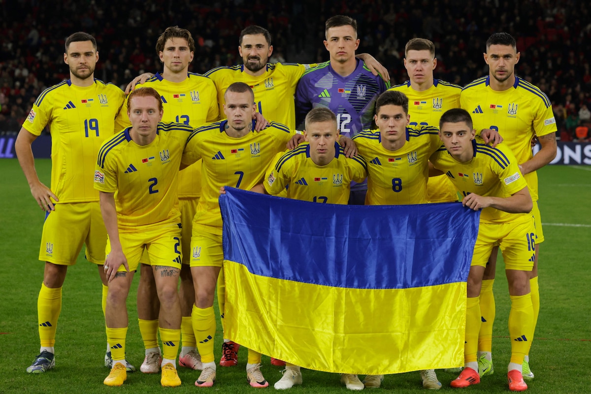 Ukraine's players pose with a Ukrainian national flag ahead of the UEFA Nations League, League B, Group 1 football match between Albania and Ukraine at the Air Albania Stadium in Tirana, on November 19, 2024. (Photo by Adnan Beci / AFP)