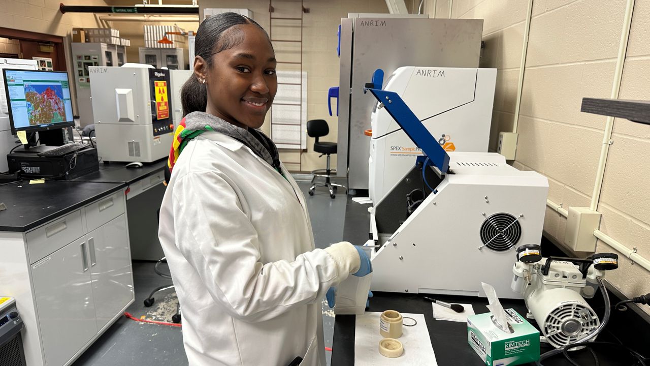 Central State University student Royalty Hightower is studying soil samples in the lab.