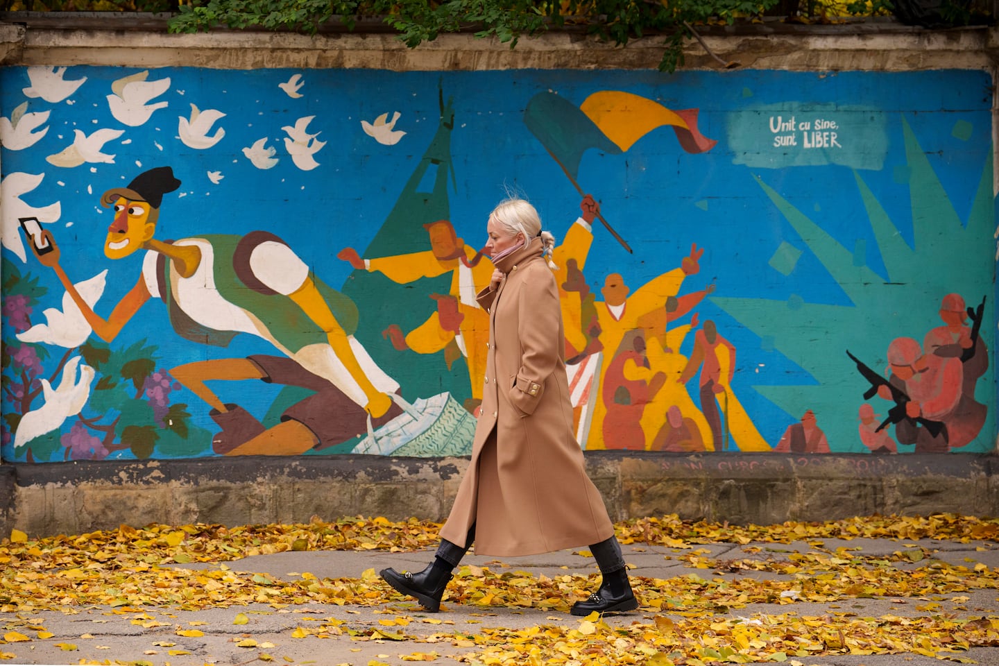 A woman walked by graffiti done in 2016 by Moldovan artists celebrating 25 years since the country declared its independence from the Soviet Union, in Chisinau, Moldova, Monday.